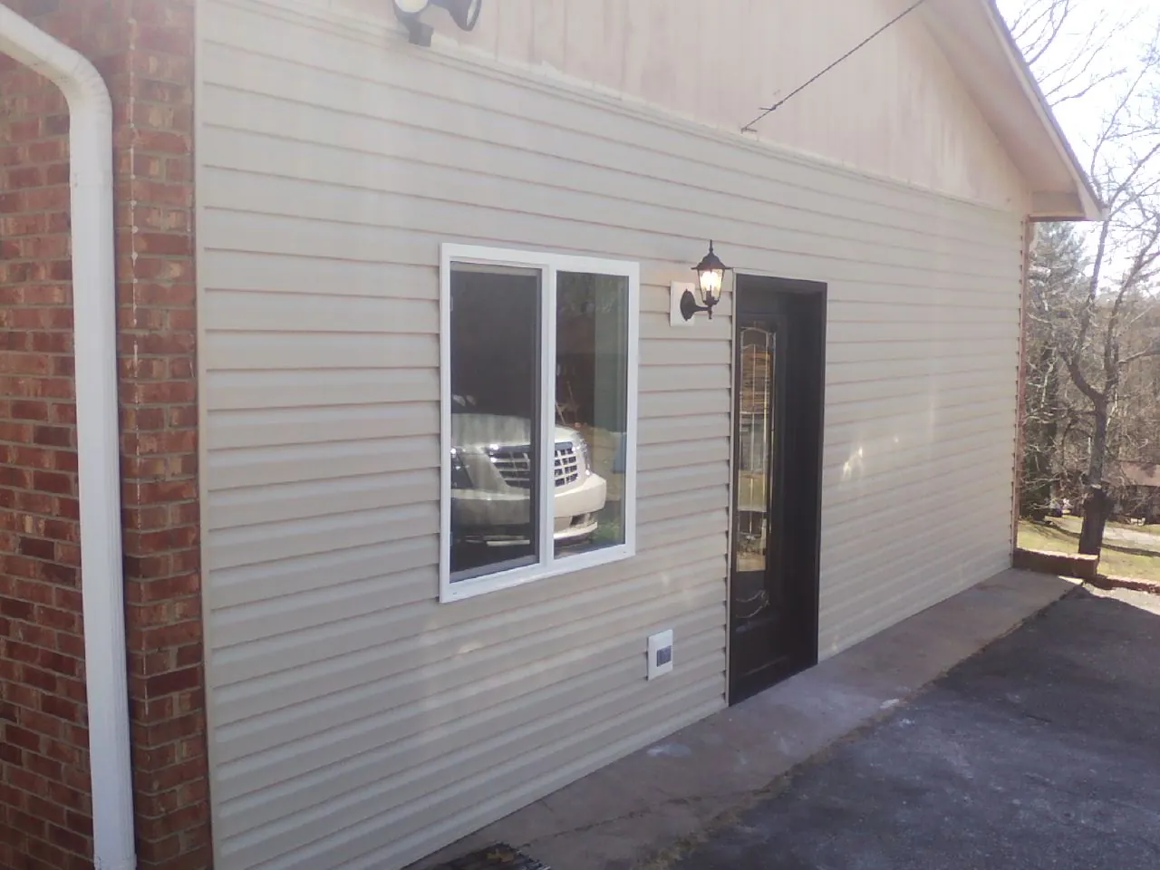 New vinyl siding and entry door on a room addition in Shiloh